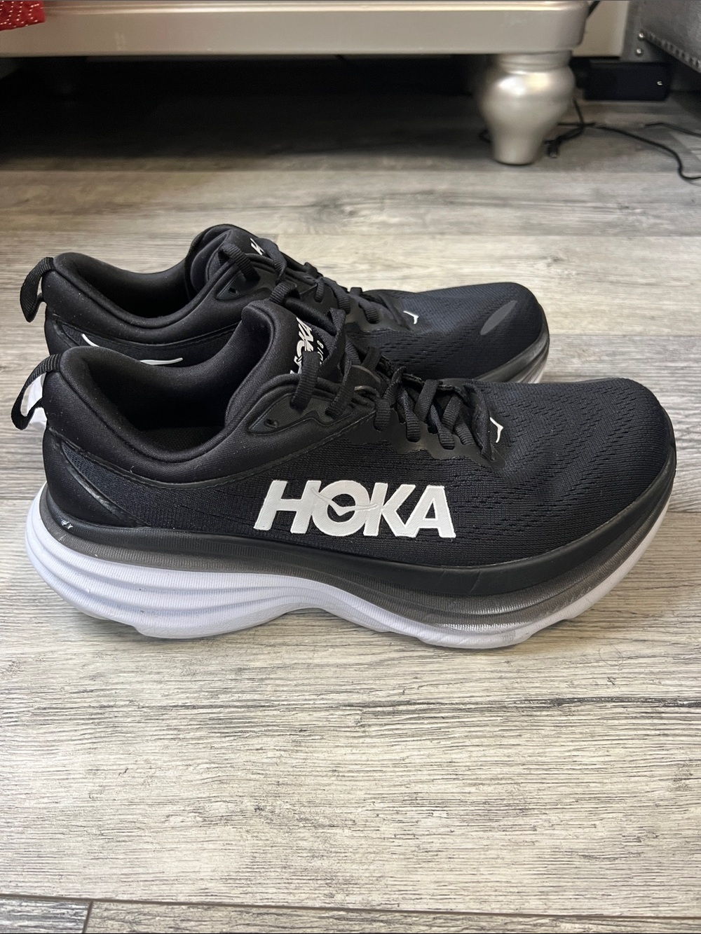 Hoka woman’s Black Athletic Running Shoes with White Midsole Accent